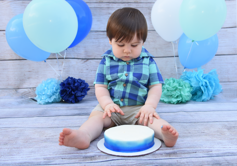 Kid looking at smash cake 